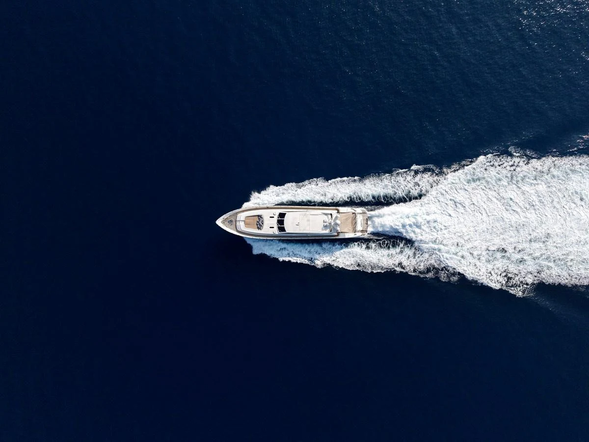 An aerial view of a sleek yacht cruising through deep blue waters. aboard CHEEKY TIGER Yacht for Sale