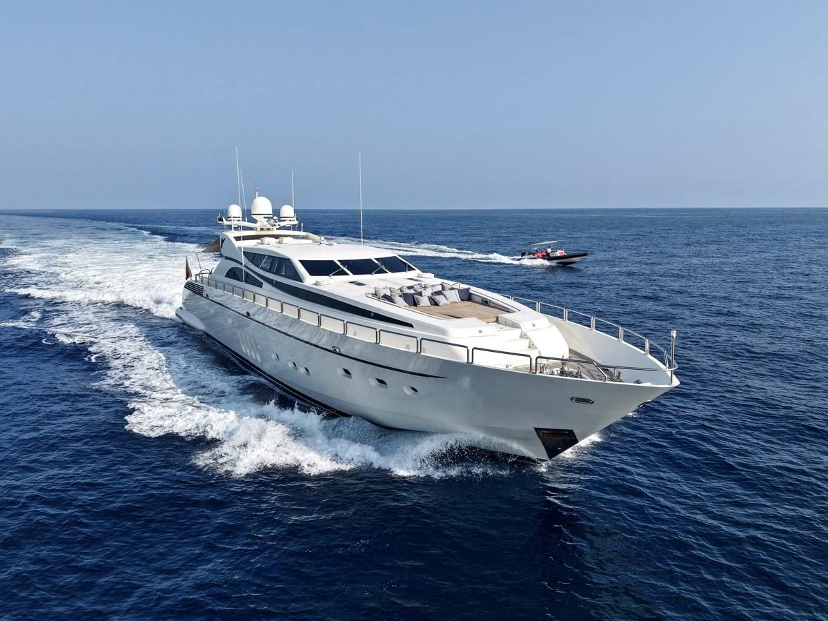 A sleek and modern yacht cruises through the open sea, showcasing its elegant design and powerful performance. aboard CHEEKY TIGER Yacht for Sale