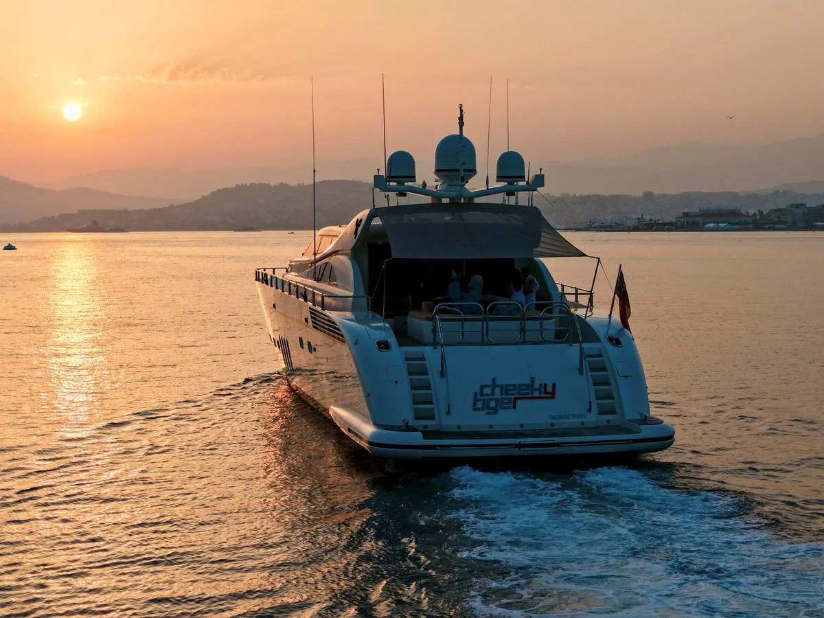The yacht sails gracefully into the sunset, showcasing its sleek design and luxurious amenities. aboard CHEEKY TIGER Yacht for Sale