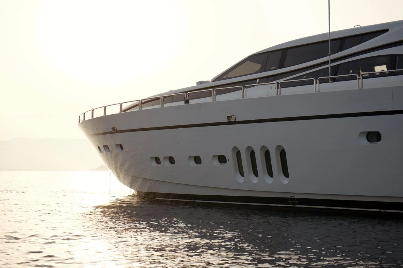 The sleek and modern yacht glides gracefully on the water at sunset. aboard CHEEKY TIGER Yacht for Sale