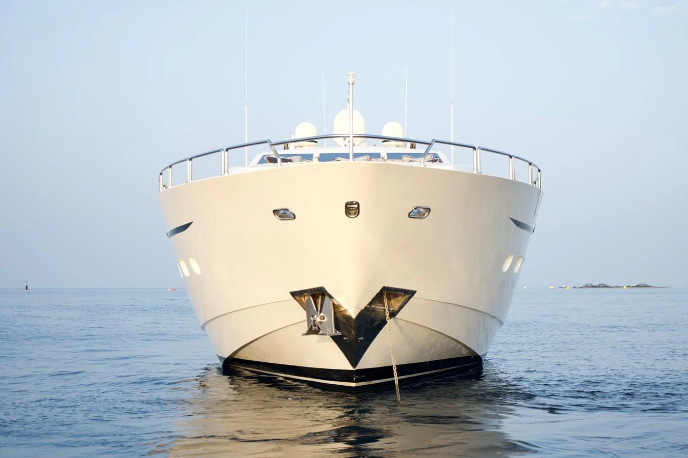 A luxurious yacht is seen head-on, showcasing its sleek design and presence on the water. aboard CHEEKY TIGER Yacht for Sale