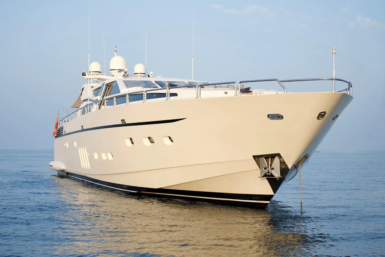 A sleek and modern yacht is anchored on calm waters, showcasing its elegant design and luxurious features. aboard CHEEKY TIGER Yacht for Sale