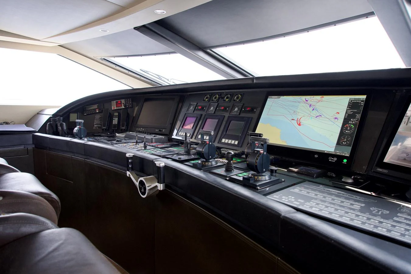 The helm station features advanced navigation and control systems with a sleek, modern design. aboard CHEEKY TIGER Yacht for Sale