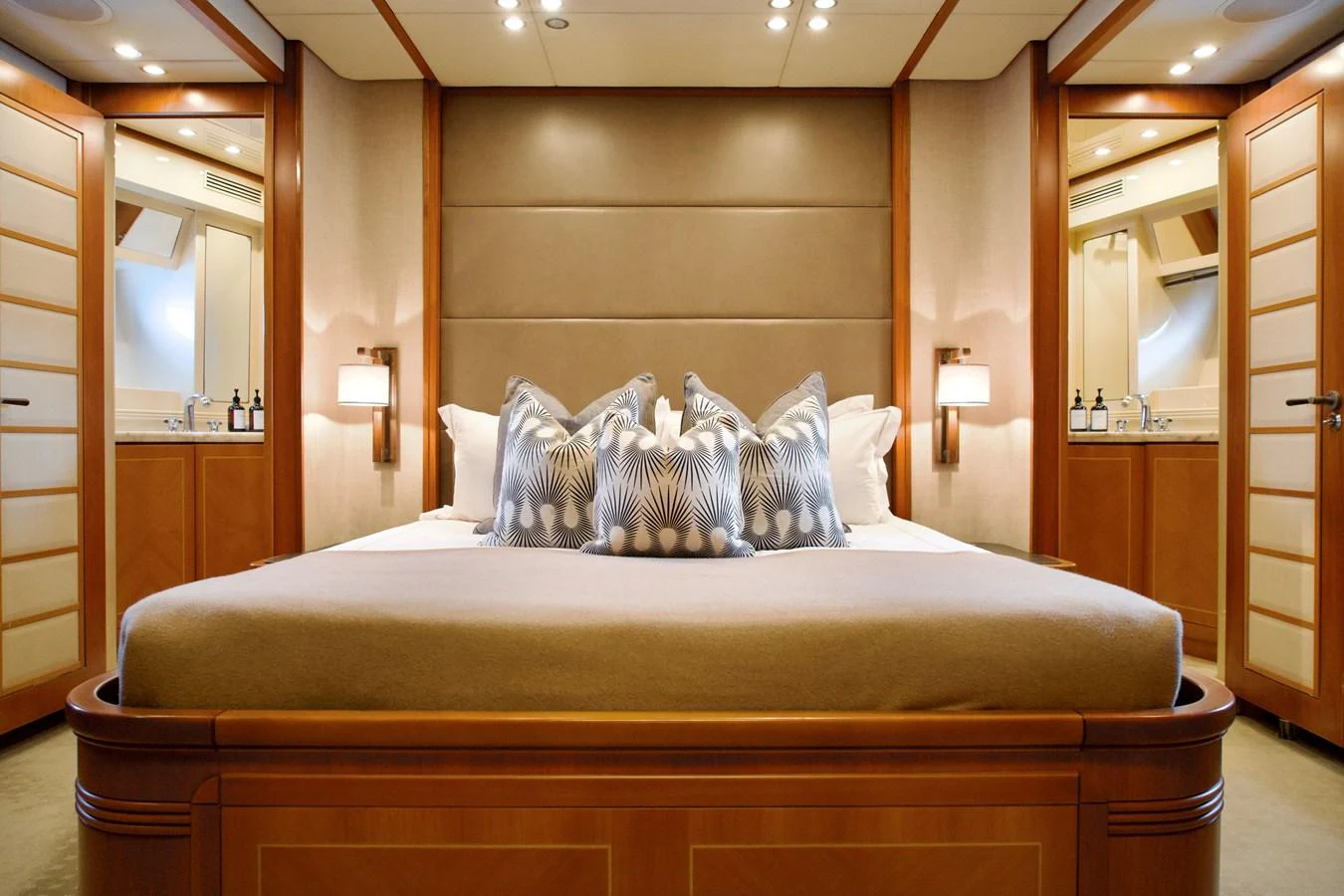 The master stateroom features a luxurious bed with elegant decor and ample lighting. aboard CHEEKY TIGER Yacht for Sale