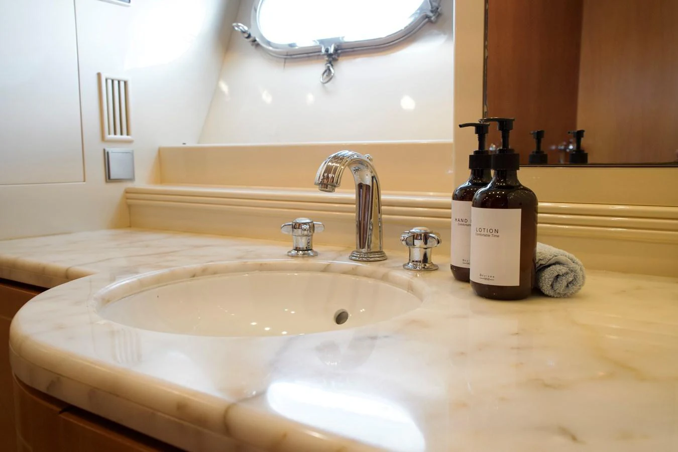 The yacht's bathroom features a sleek marble countertop with elegant fixtures and luxury toiletries. aboard CHEEKY TIGER Yacht for Sale