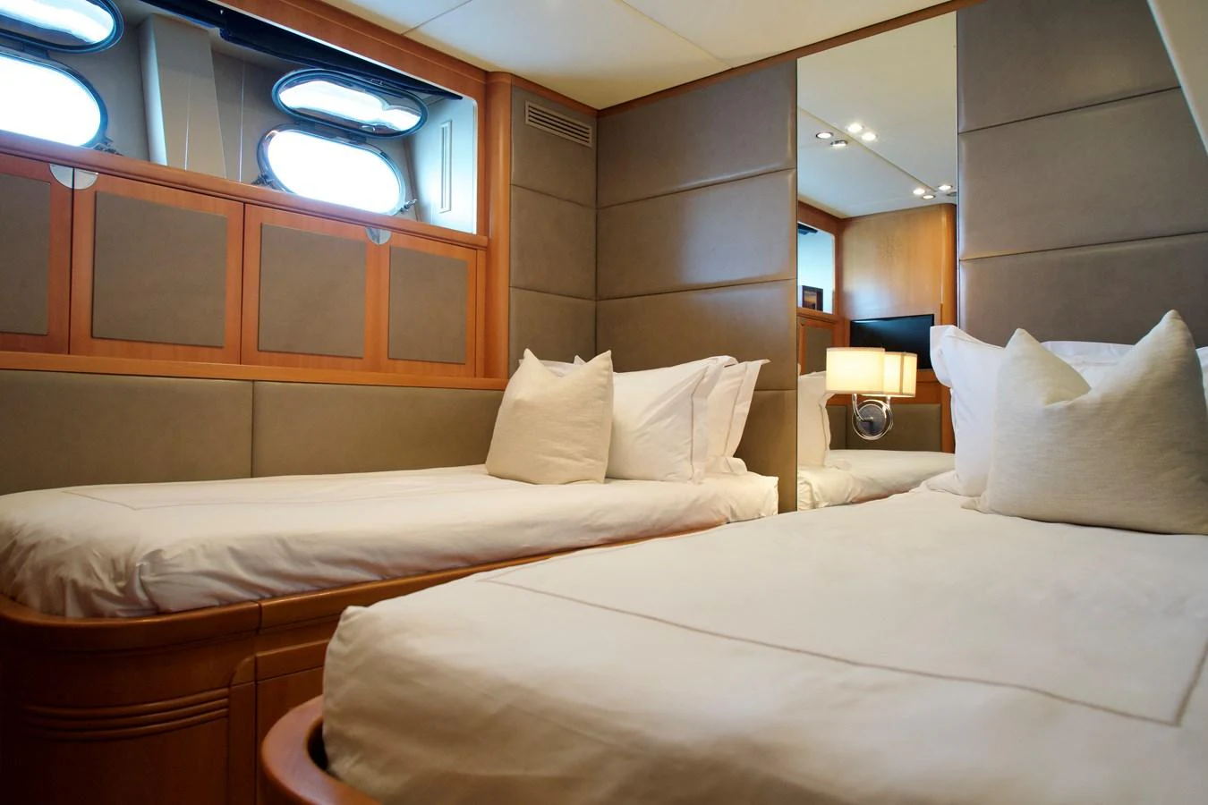 The guest stateroom features twin beds with plush pillows and modern decor. aboard CHEEKY TIGER Yacht for Sale