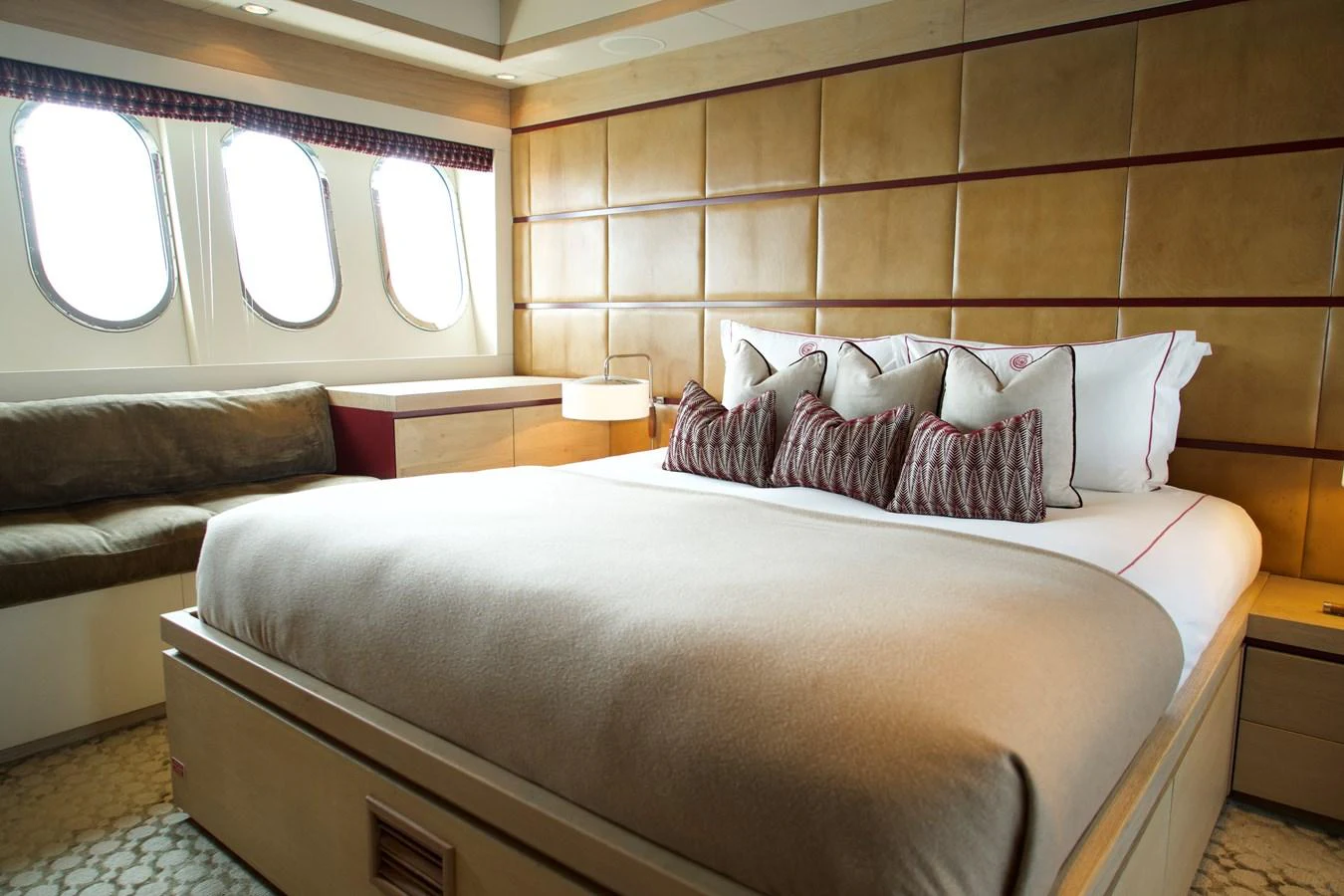 The stateroom features a plush bed with elegant bedding and ample natural light from the large windows. aboard CHEEKY TIGER Yacht for Sale