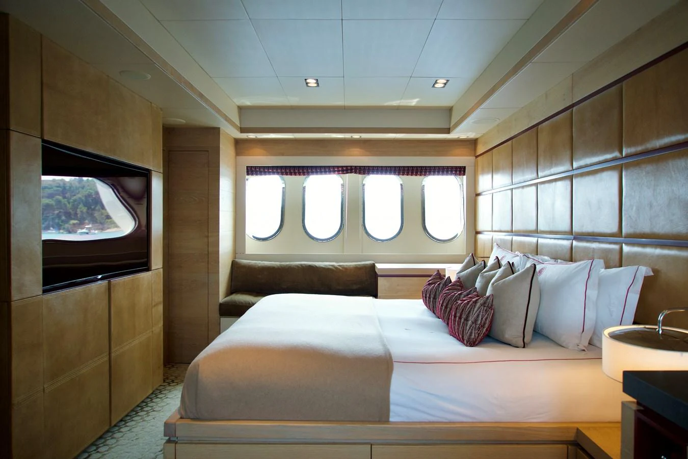 The stateroom features a luxurious bed, ample natural light from large windows, and elegant decor. aboard CHEEKY TIGER Yacht for Sale