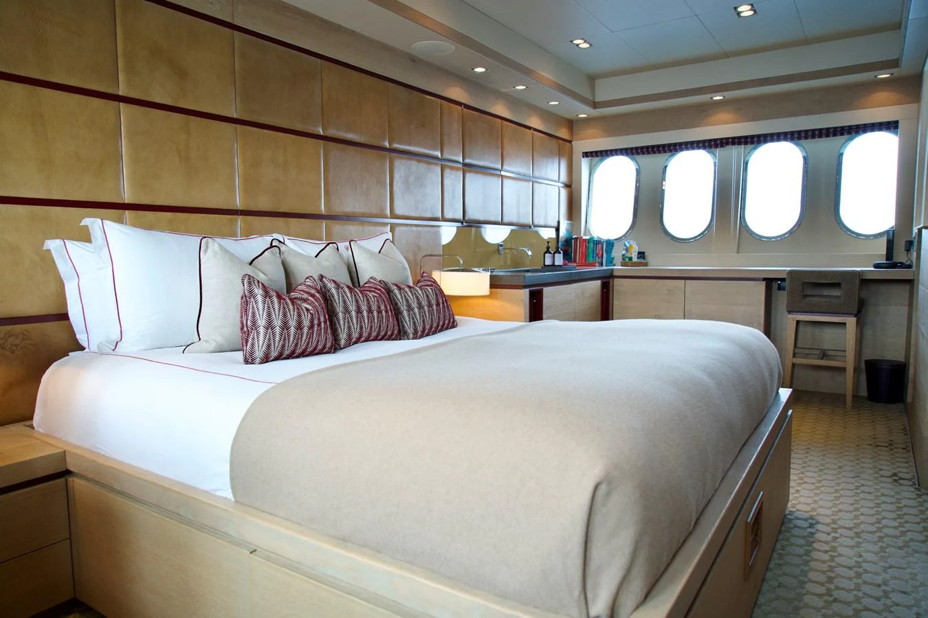 The master stateroom features a luxurious bed with elegant decor and ample natural light from large windows. aboard CHEEKY TIGER Yacht for Sale