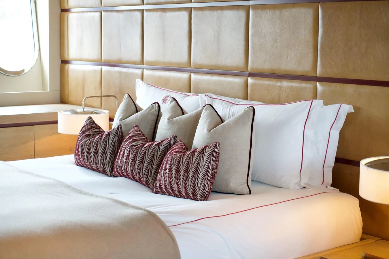 The stateroom features a plush bed with elegant pillows and a stylish headboard. aboard CHEEKY TIGER Yacht for Sale