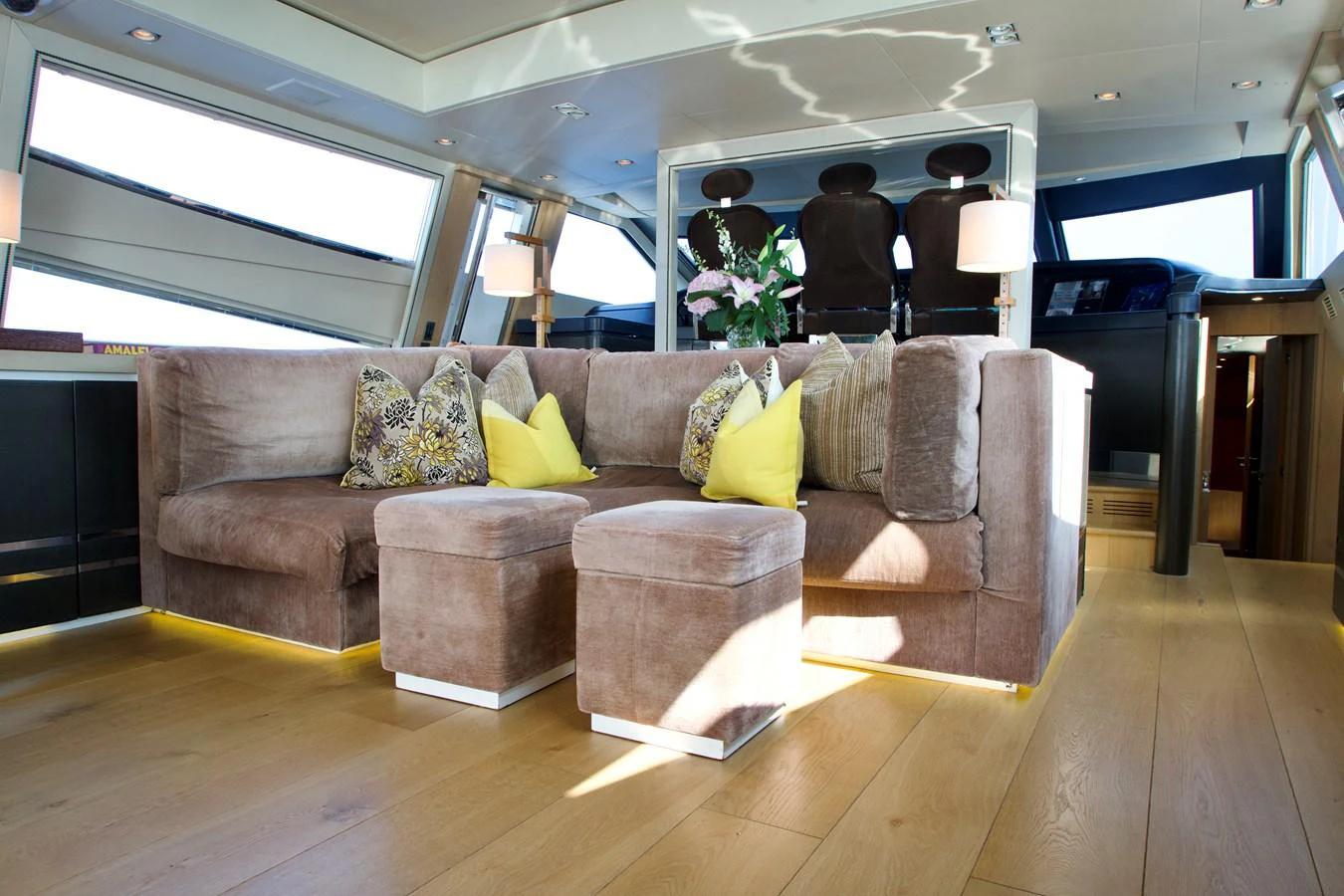 The salon features a plush seating area with modern decor and ample natural light. aboard CHEEKY TIGER Yacht for Sale
