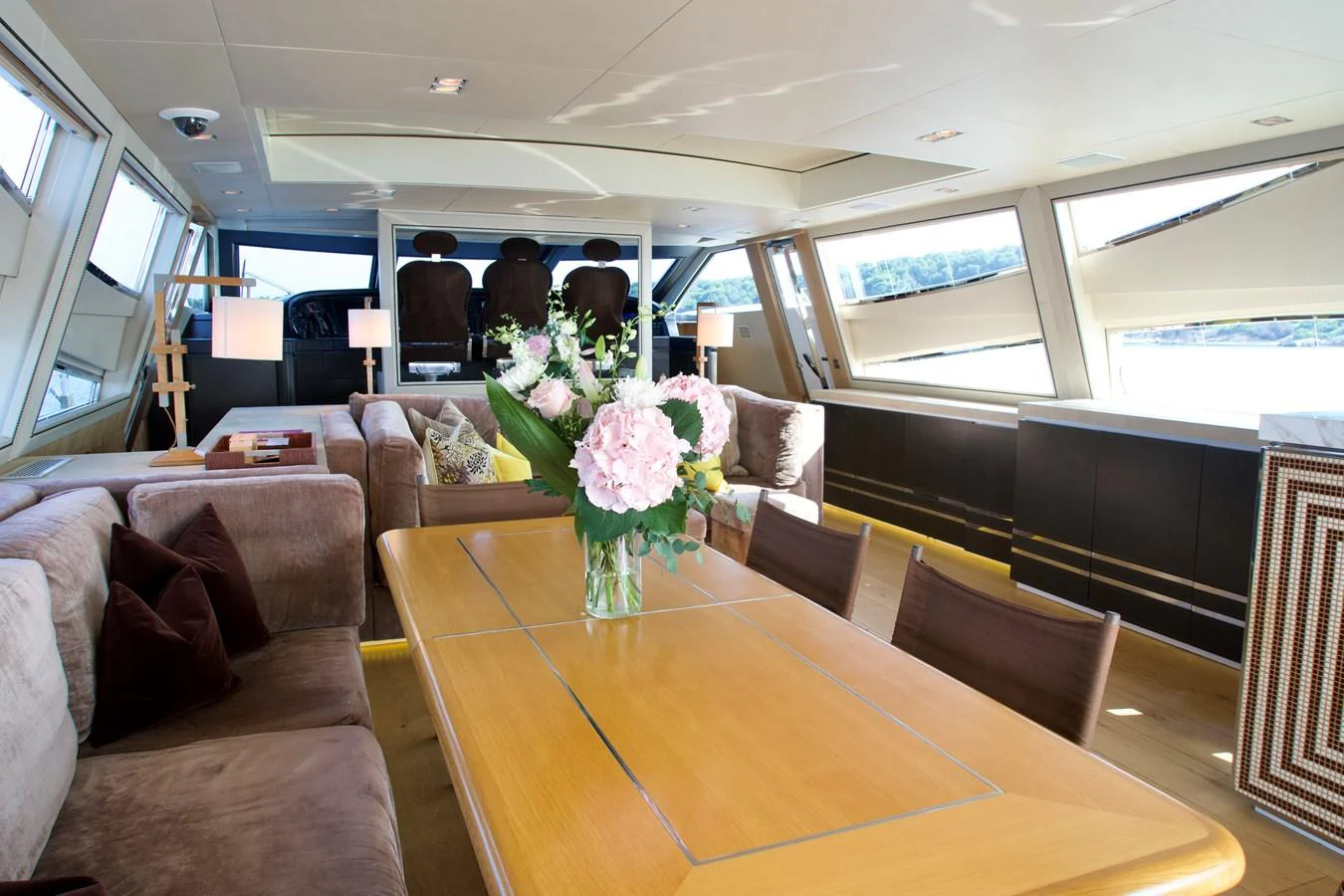 The yacht's salon features a spacious and elegantly decorated dining area with large windows providing ample natural light. aboard CHEEKY TIGER Yacht for Sale