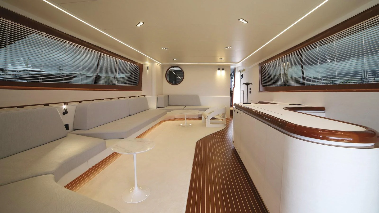 The salon features a spacious seating area with modern furnishings and elegant wood accents. aboard MAVERICK Yacht for Sale
