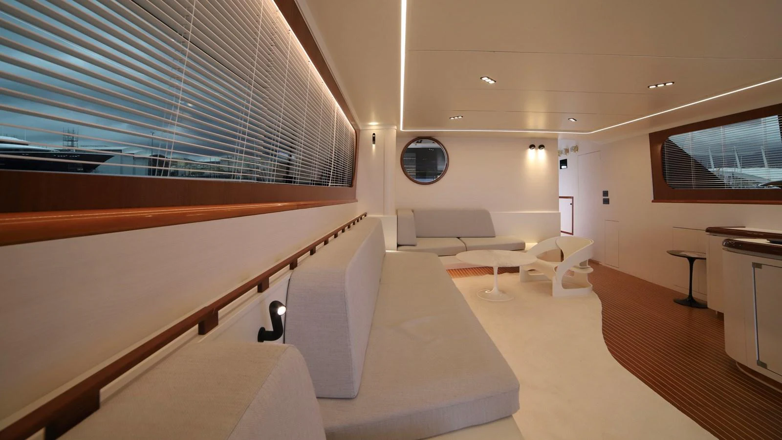 The salon features modern furnishings with ample seating and large windows for natural light. aboard MAVERICK Yacht for Sale