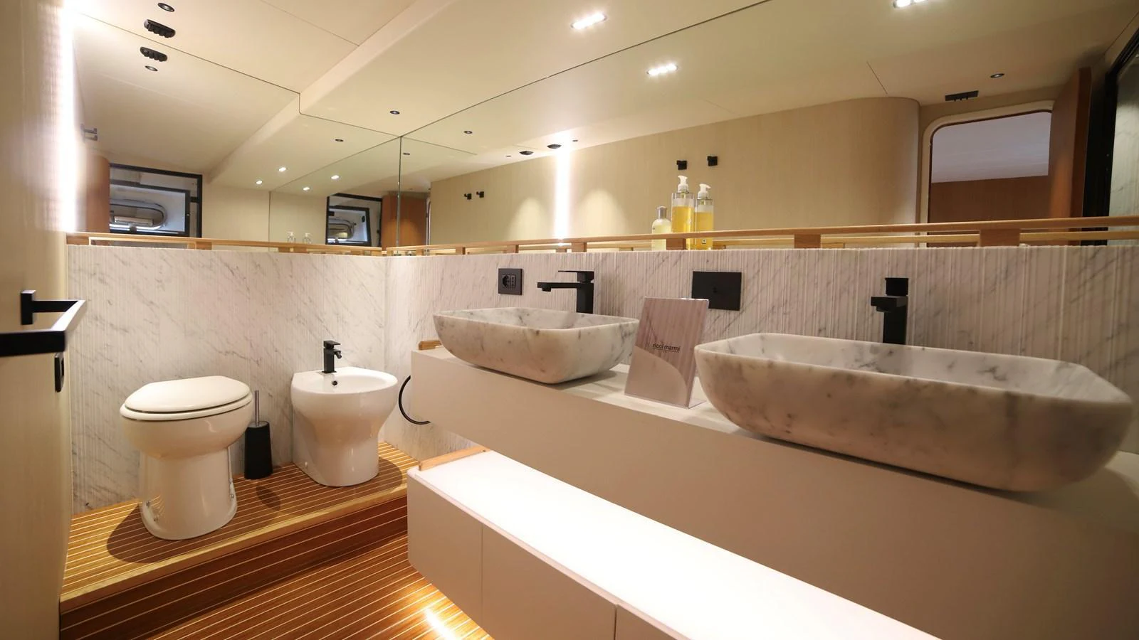 The yacht's bathroom features a sleek, modern design with dual sinks and elegant fixtures. aboard MAVERICK Yacht for Sale