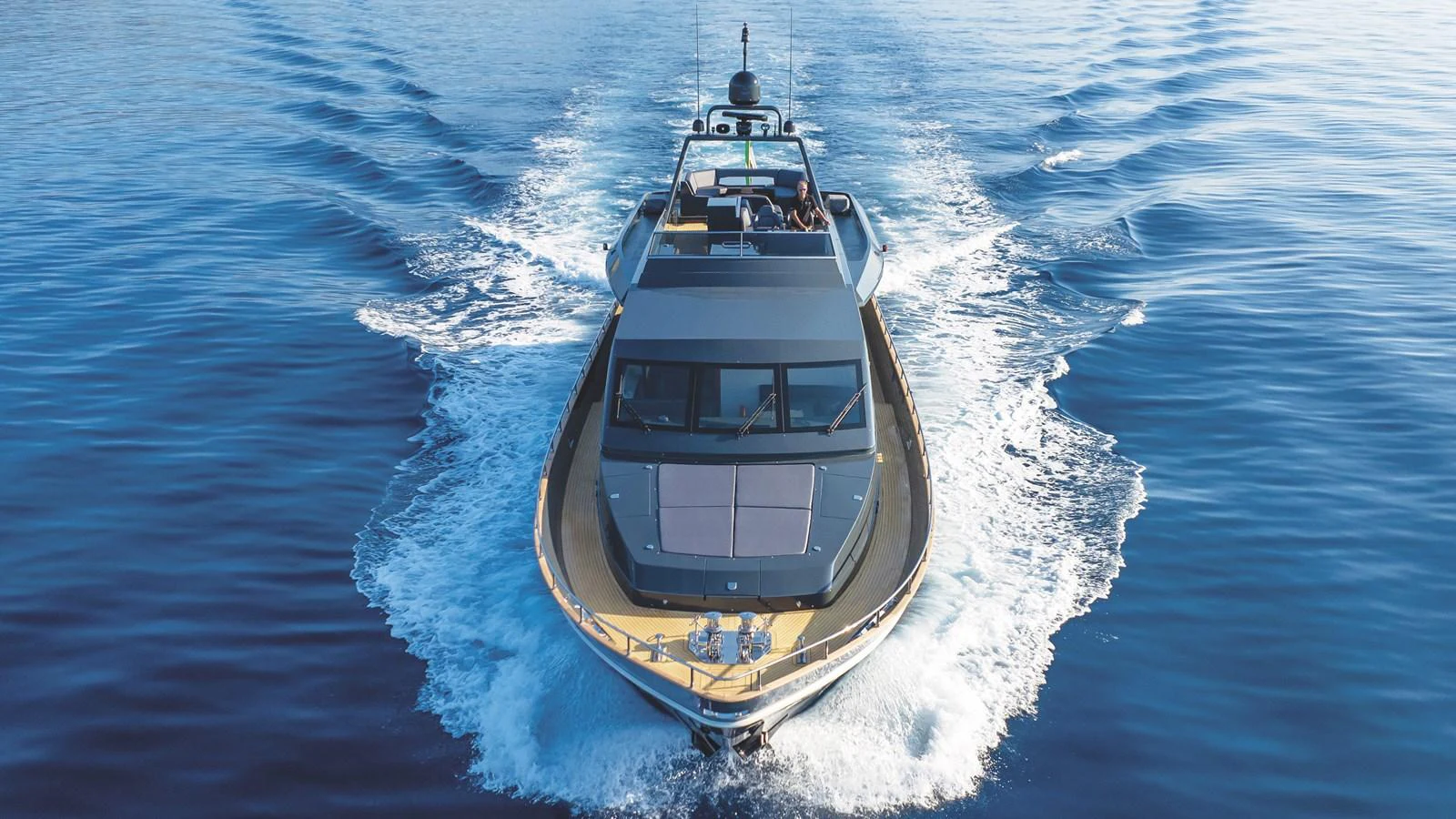 A sleek yacht cruises through calm blue waters, showcasing its modern design and powerful performance. aboard MAVERICK Yacht for Sale