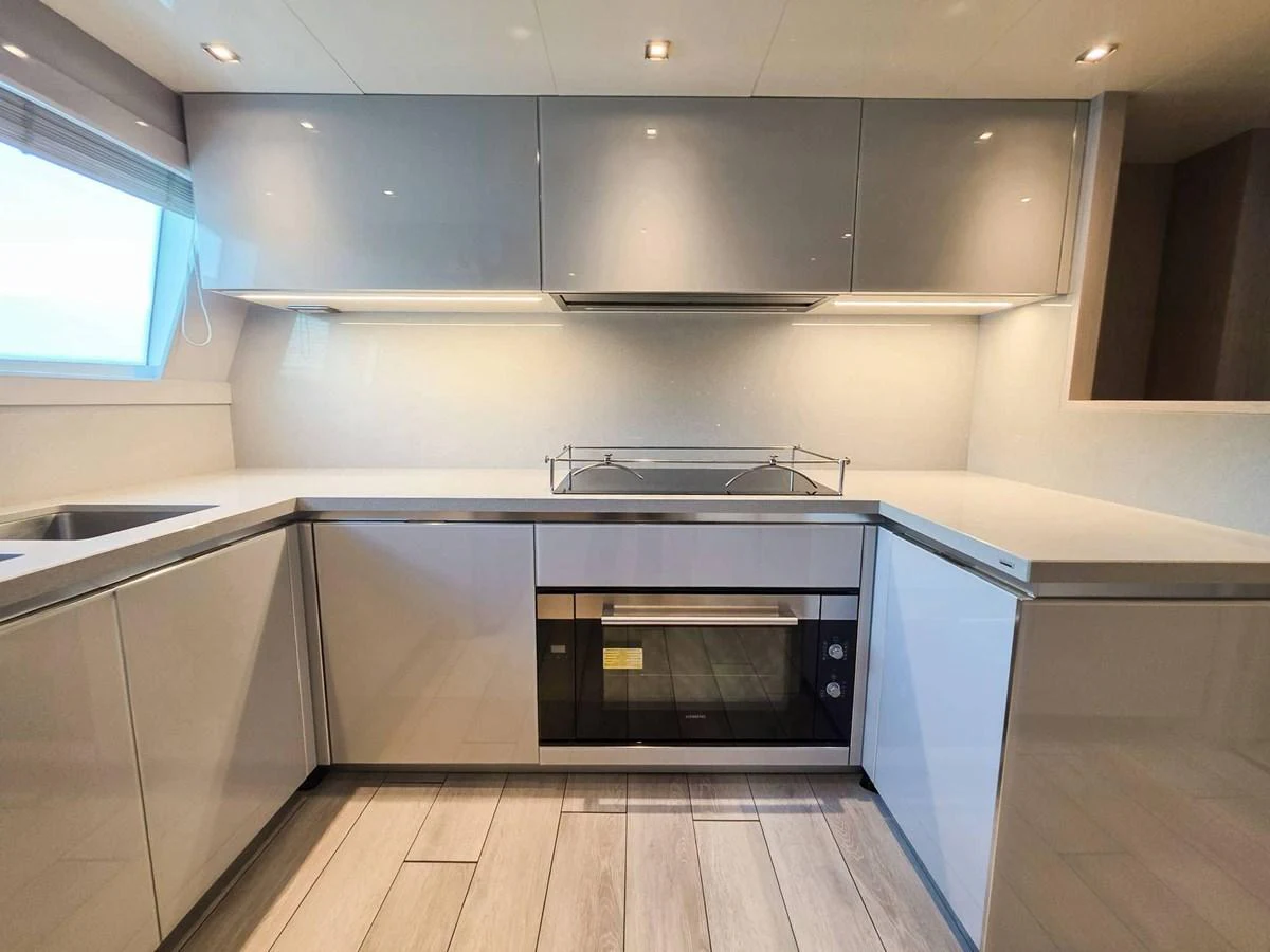 a kitchen with a stove and oven aboard CUSTOM LINE 108 Yacht for Sale