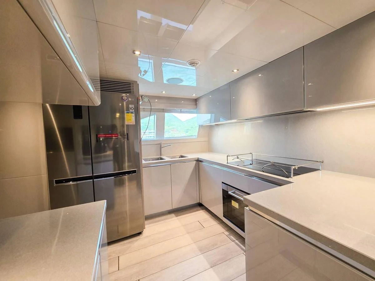 a kitchen with stainless steel appliances aboard CUSTOM LINE 108 Yacht for Sale
