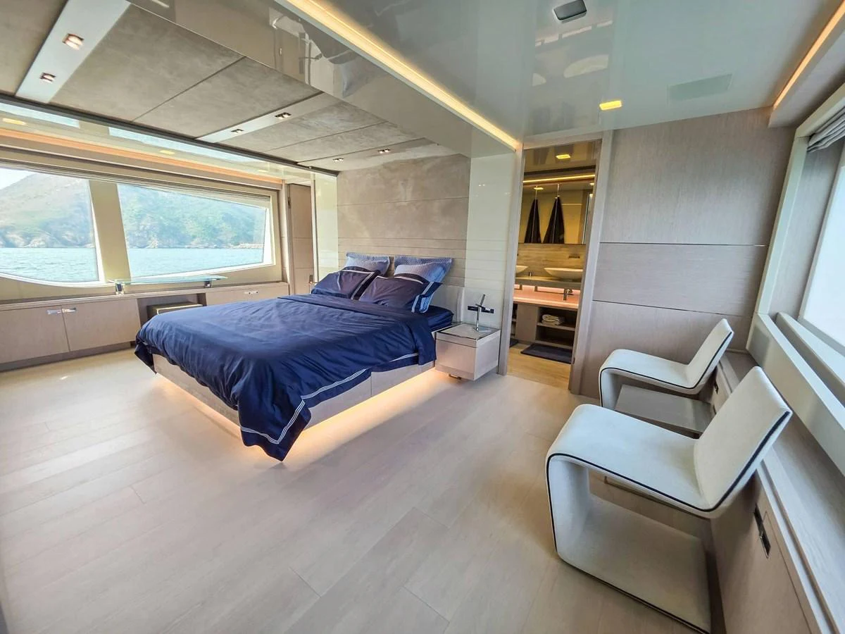 a bedroom with a large bed aboard CUSTOM LINE 108 Yacht for Sale