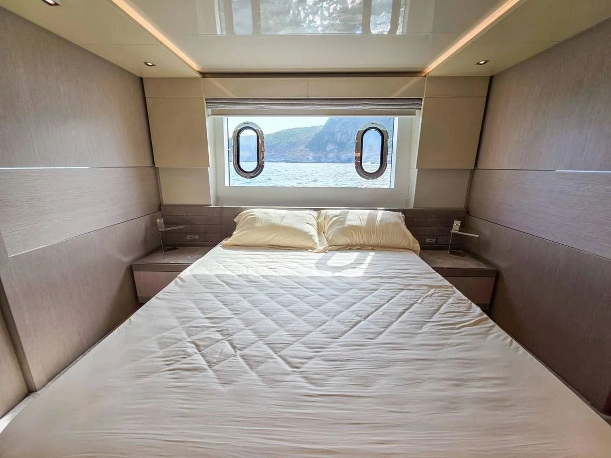 a bed with a picture on the wall aboard CUSTOM LINE 108 Yacht for Sale