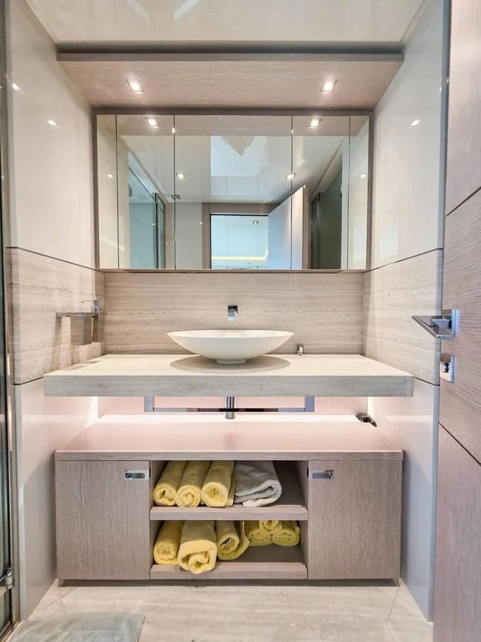 a bathroom with a sink and a mirror aboard CUSTOM LINE 108 Yacht for Sale