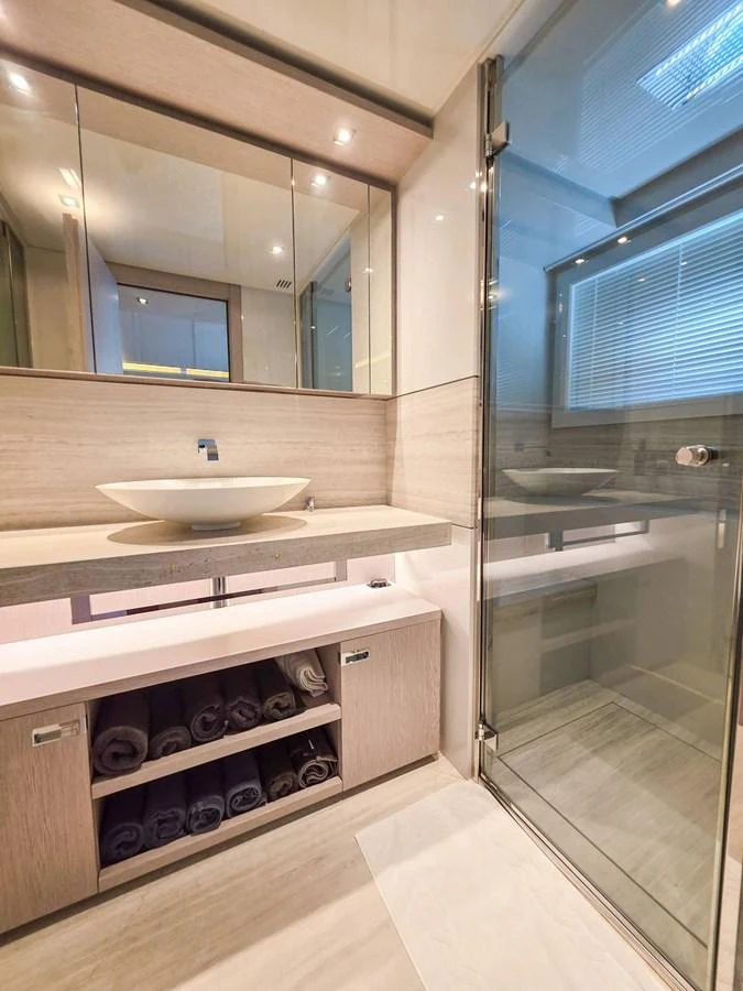 a bathroom with a sink and a mirror aboard CUSTOM LINE 108 Yacht for Sale