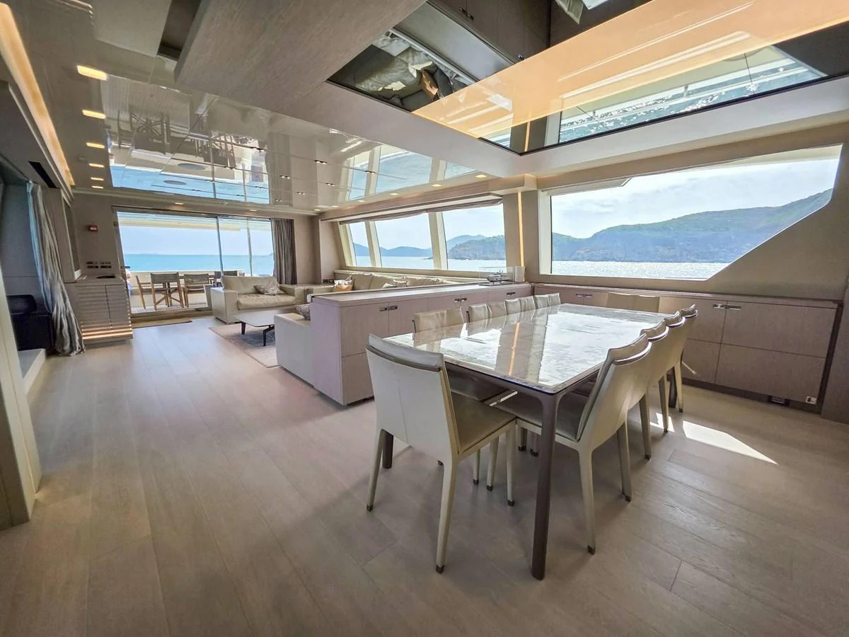 a large room with a table and chairs aboard CUSTOM LINE 108 Yacht for Sale