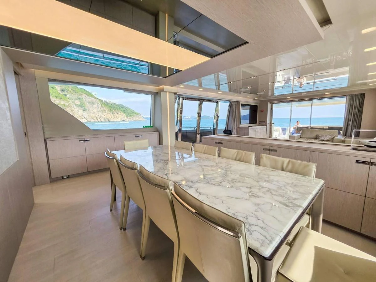 a room with a table and chairs aboard CUSTOM LINE 108 Yacht for Sale