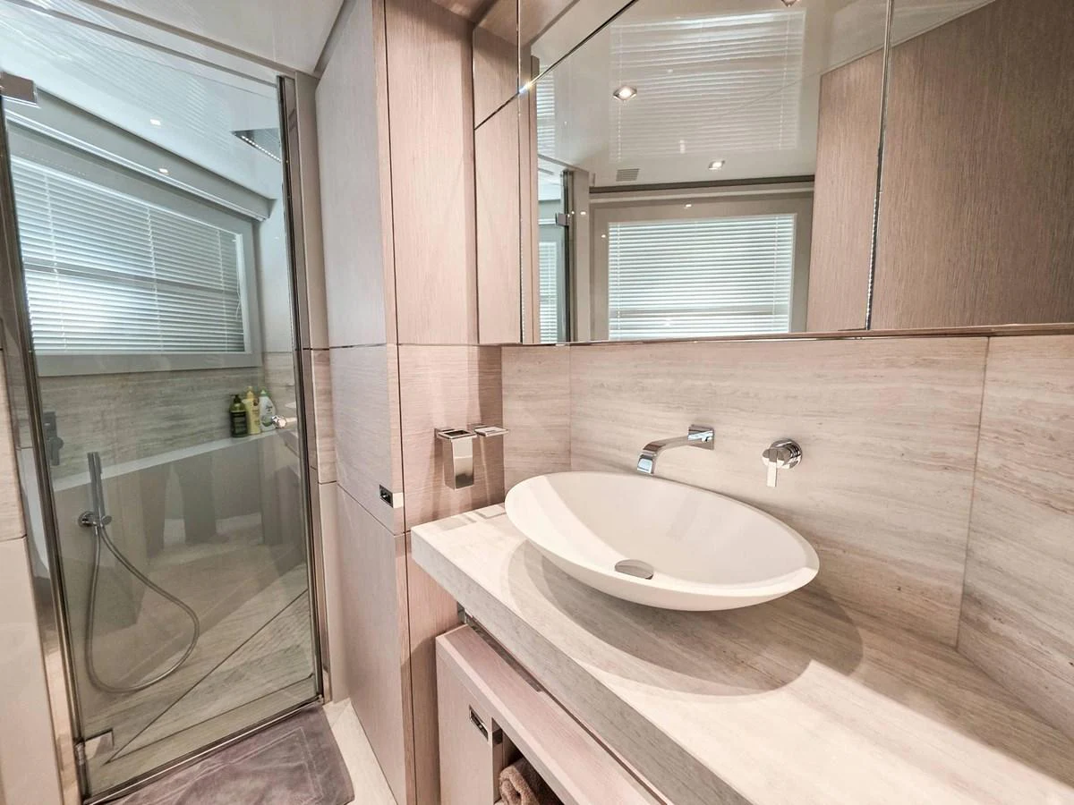 a bathroom with a sink and a mirror aboard CUSTOM LINE 108 Yacht for Sale