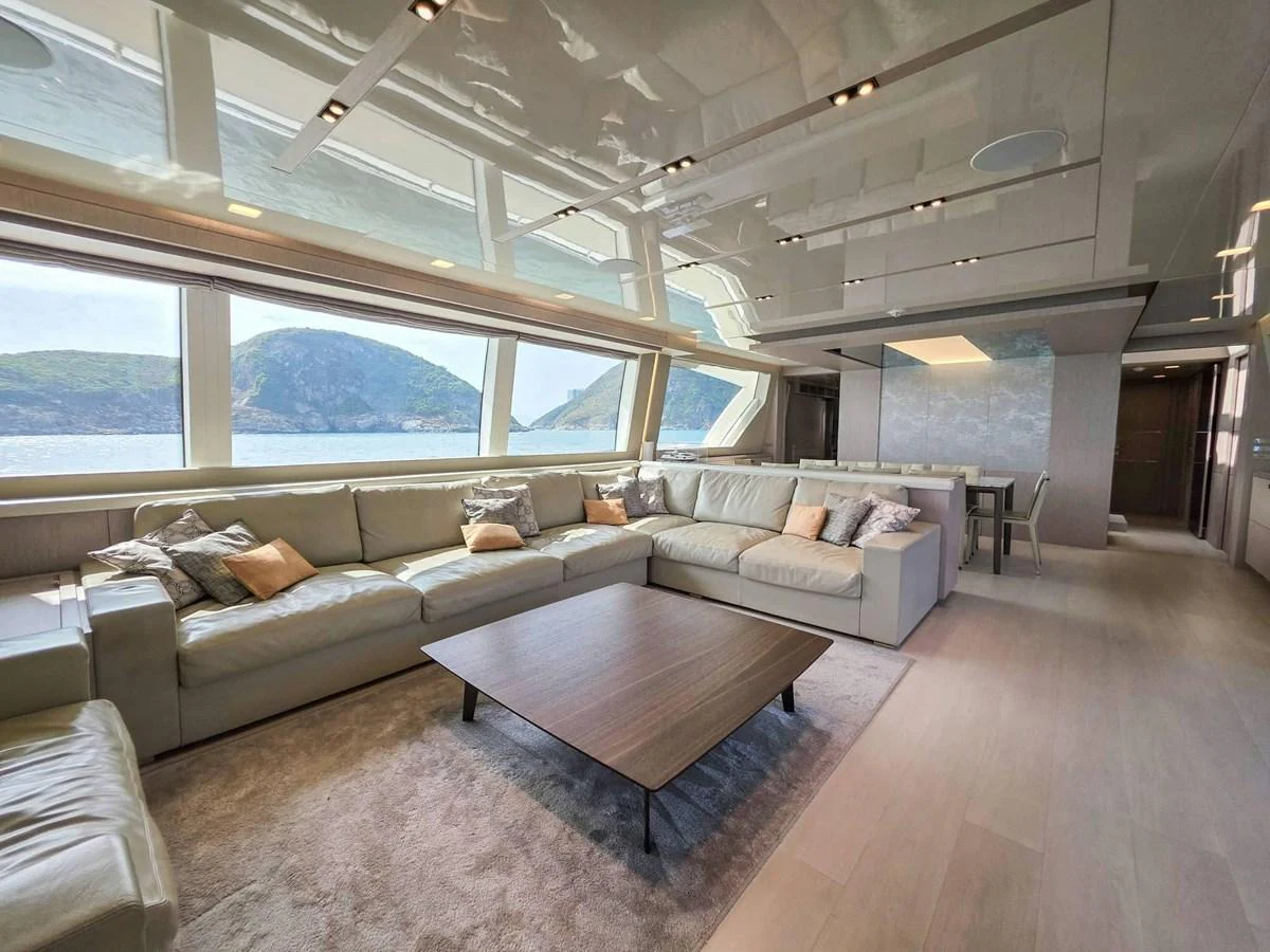 a living room with a large window aboard CUSTOM LINE 108 Yacht for Sale