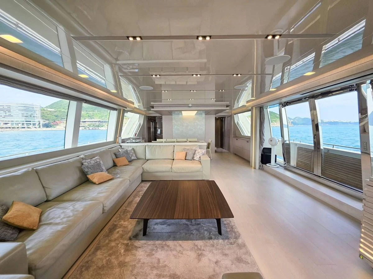 a room with a couch and a table aboard CUSTOM LINE 108 Yacht for Sale