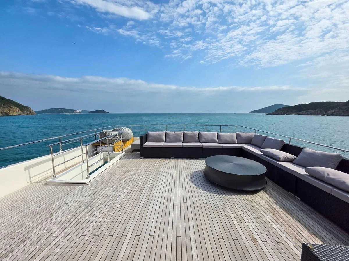 a deck with a view of the ocean and a large boat in the water aboard CUSTOM LINE 108 Yacht for Sale