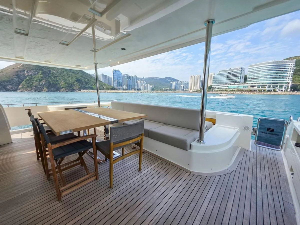 a table and chairs on a deck aboard CUSTOM LINE 108 Yacht for Sale