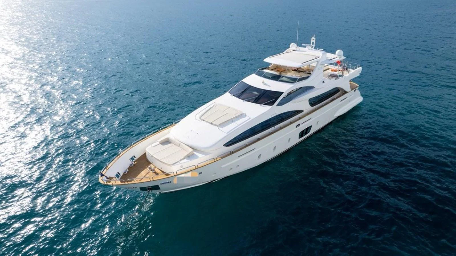 A luxurious yacht glides gracefully on the open sea, showcasing its sleek design and spacious deck areas. aboard AZIMUT 105 Yacht for Sale