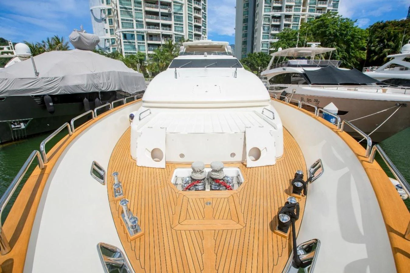 The foredeck of the yacht features a spacious teak deck with modern fittings and a clean, elegant design. aboard AZIMUT 105 Yacht for Sale