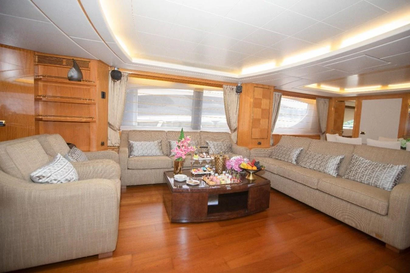 The salon features plush seating and a beautifully arranged coffee table, creating a cozy and inviting atmosphere. aboard AZIMUT 105 Yacht for Sale