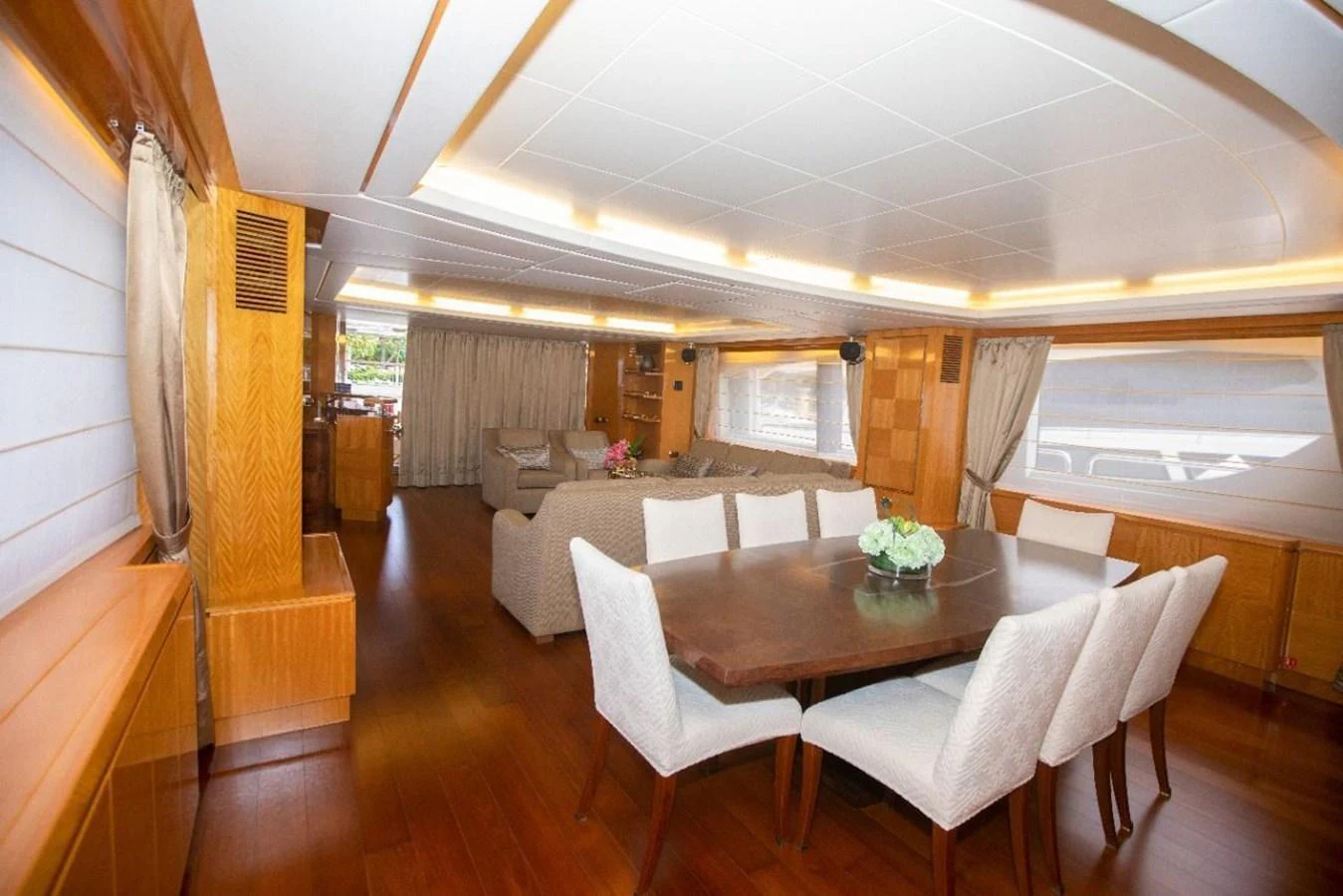 The yacht's interior dining area features a spacious table with comfortable seating and elegant decor. aboard AZIMUT 105 Yacht for Sale