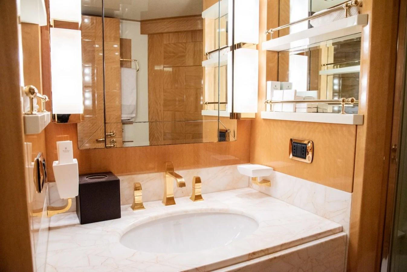 The bathroom features elegant fixtures and a luxurious marble countertop. aboard AZIMUT 105 Yacht for Sale