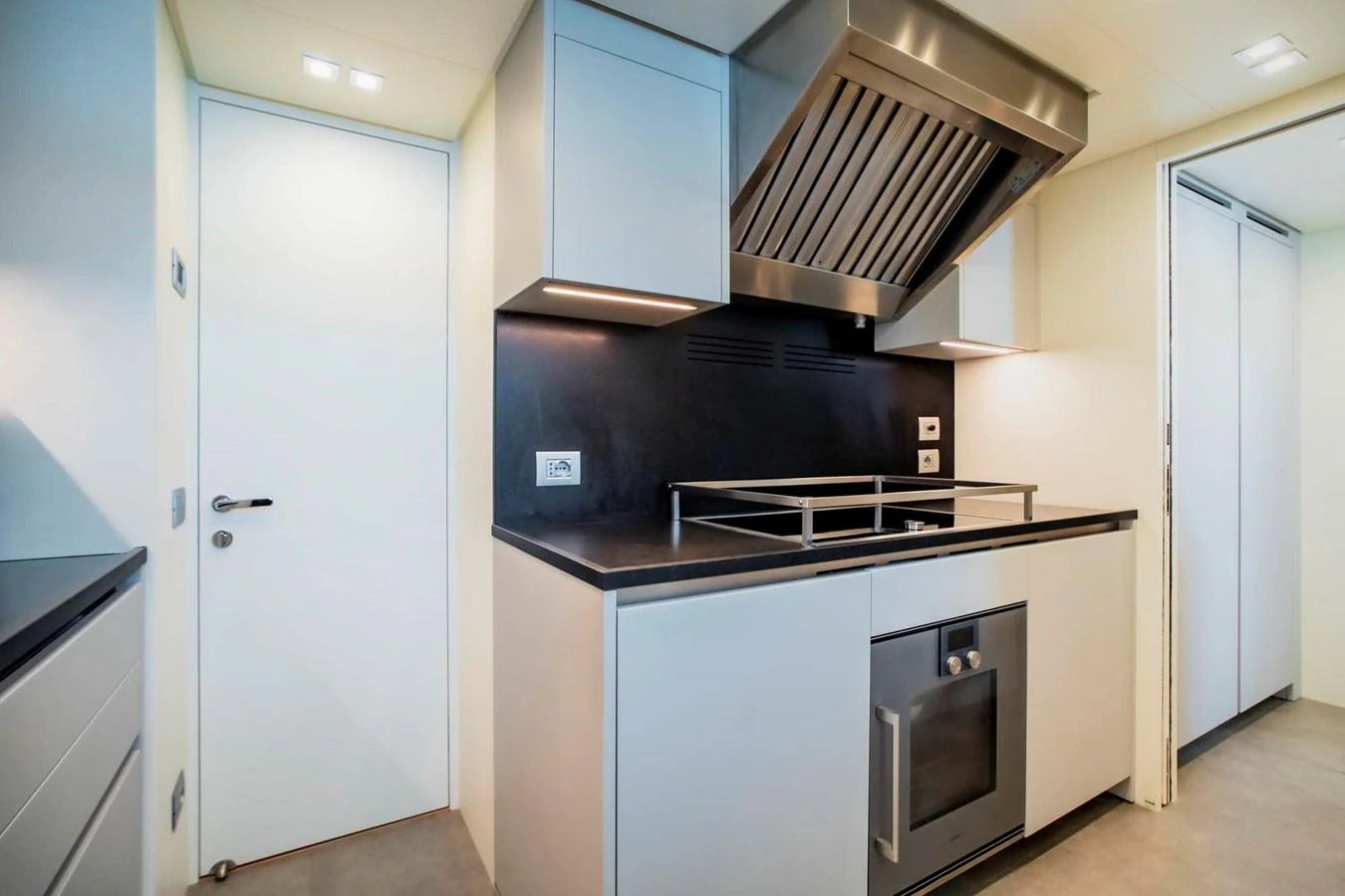 The yacht's galley features modern appliances and sleek cabinetry, perfect for gourmet cooking at sea. aboard SANLORENZO SX100 Yacht for Sale
