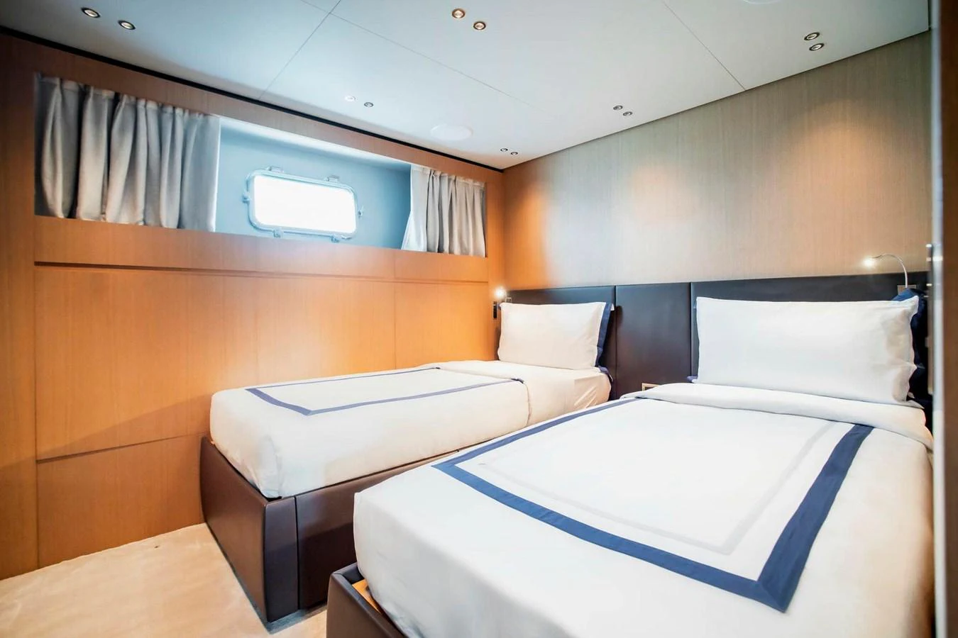 The guest stateroom features twin beds with elegant bedding and a modern, minimalist design. aboard SANLORENZO SX100 Yacht for Sale
