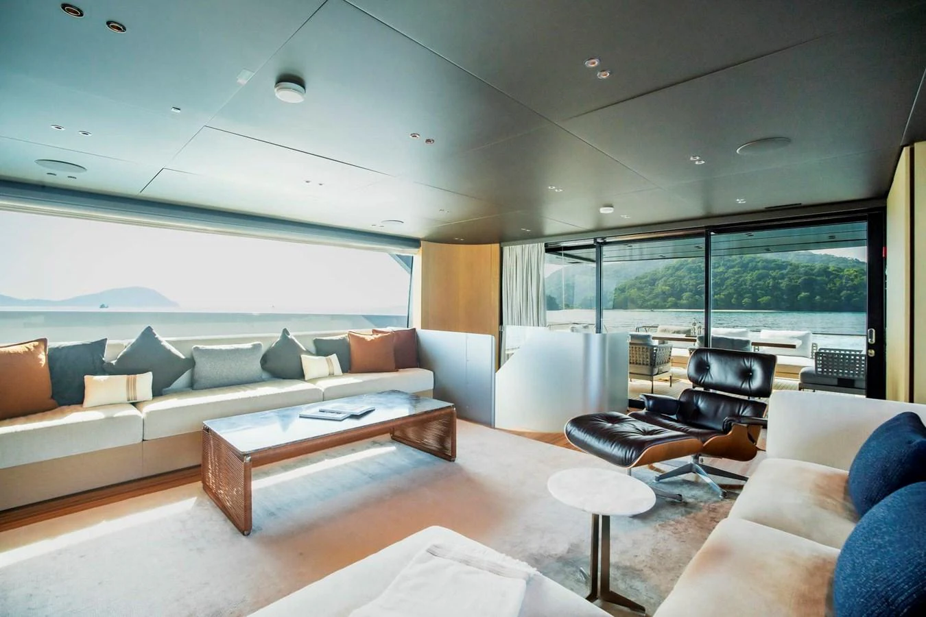 The salon features expansive windows offering stunning views and ample natural light, complemented by luxurious seating and modern decor. aboard SANLORENZO SX100 Yacht for Sale