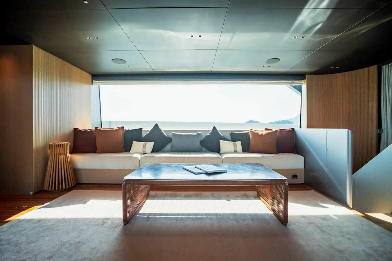The salon features a spacious seating area with a large window providing ample natural light. aboard SANLORENZO SX100 Yacht for Sale