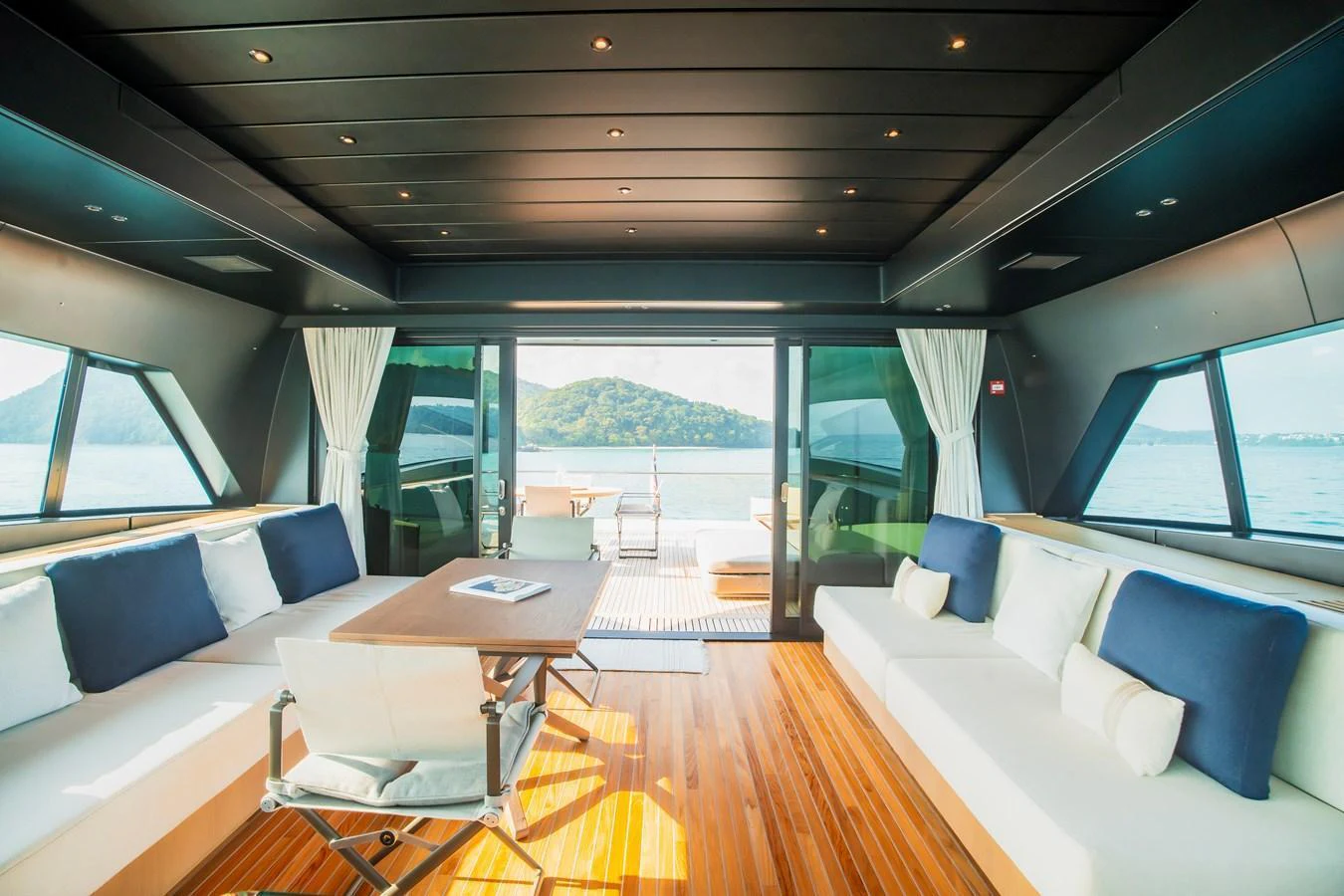 The salon offers a spacious and luxurious area with panoramic views and elegant furnishings. aboard SANLORENZO SX100 Yacht for Sale