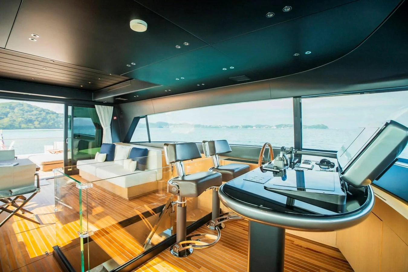 The helm area features luxurious seating and a panoramic view of the surrounding waters. aboard SANLORENZO SX100 Yacht for Sale