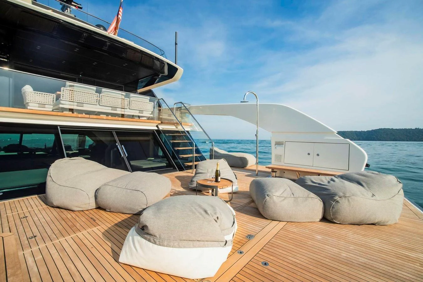 The aft deck features a luxurious lounging area with plush bean bags and a stunning ocean view. aboard SANLORENZO SX100 Yacht for Sale