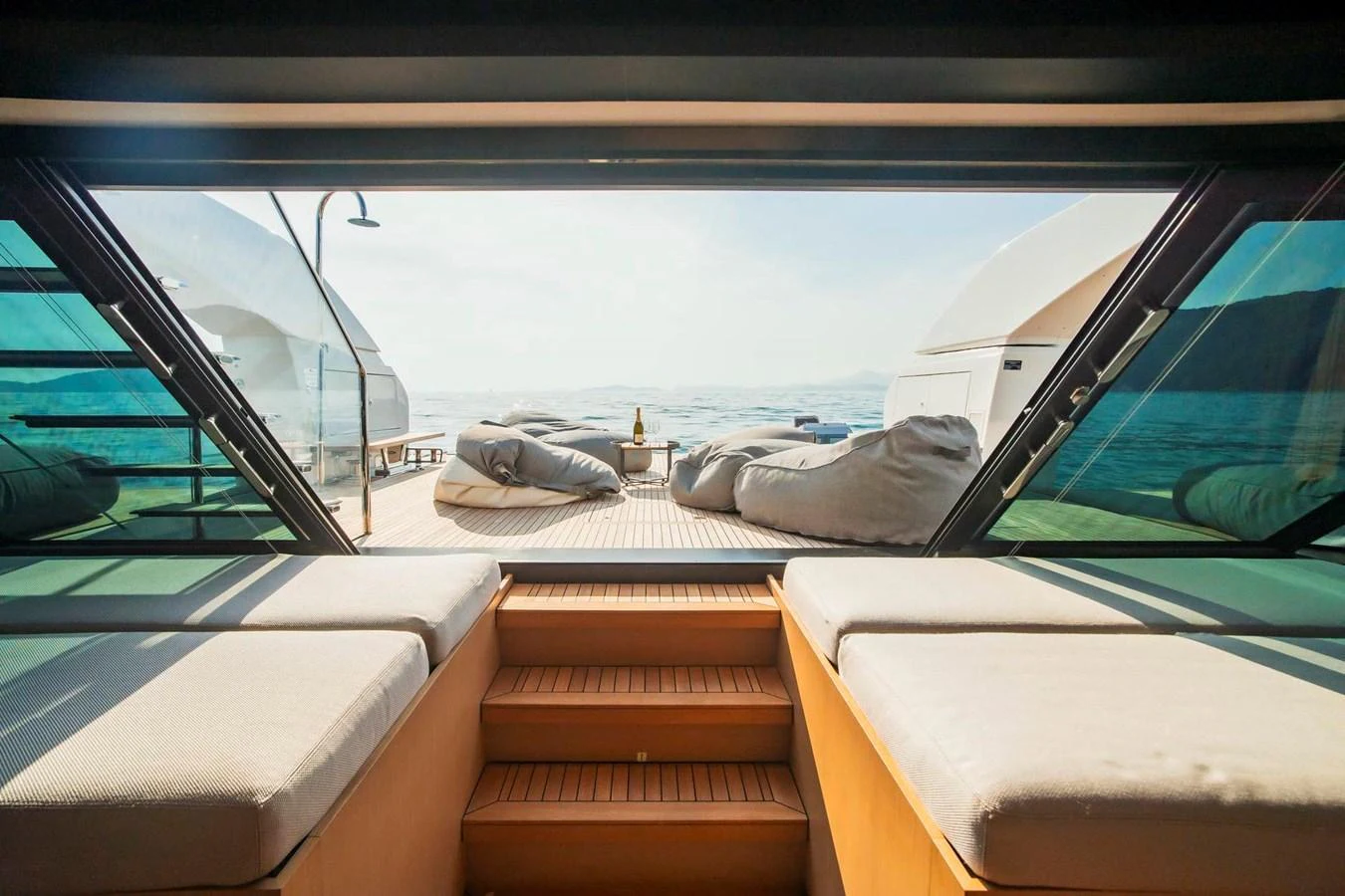 The aft deck offers a serene view of the sea, complemented by comfortable seating and bean bags. aboard SANLORENZO SX100 Yacht for Sale