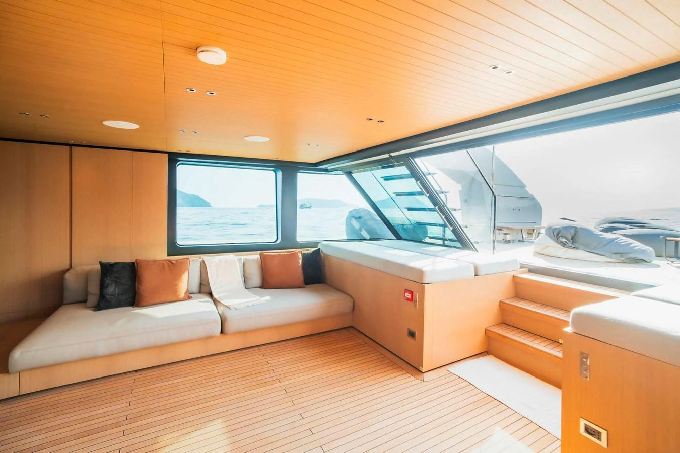 The salon features a spacious, sunlit lounging area with large windows and modern furnishings. aboard SANLORENZO SX100 Yacht for Sale