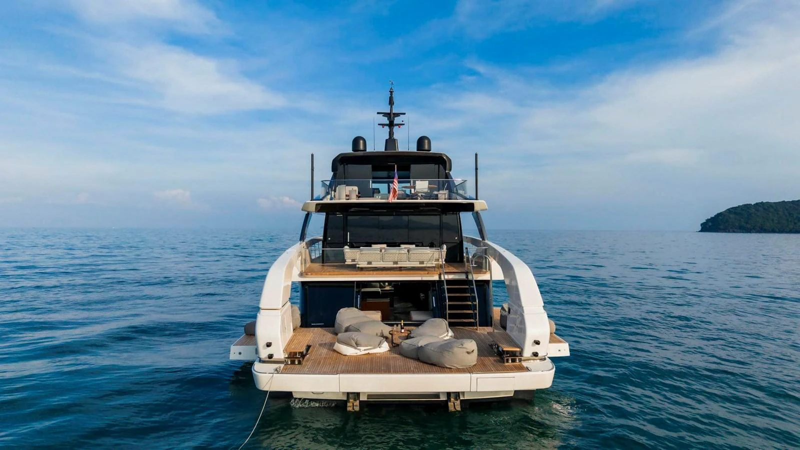 The yacht's aft deck offers a luxurious lounging area with a stunning view of the open sea. aboard SANLORENZO SX100 Yacht for Sale