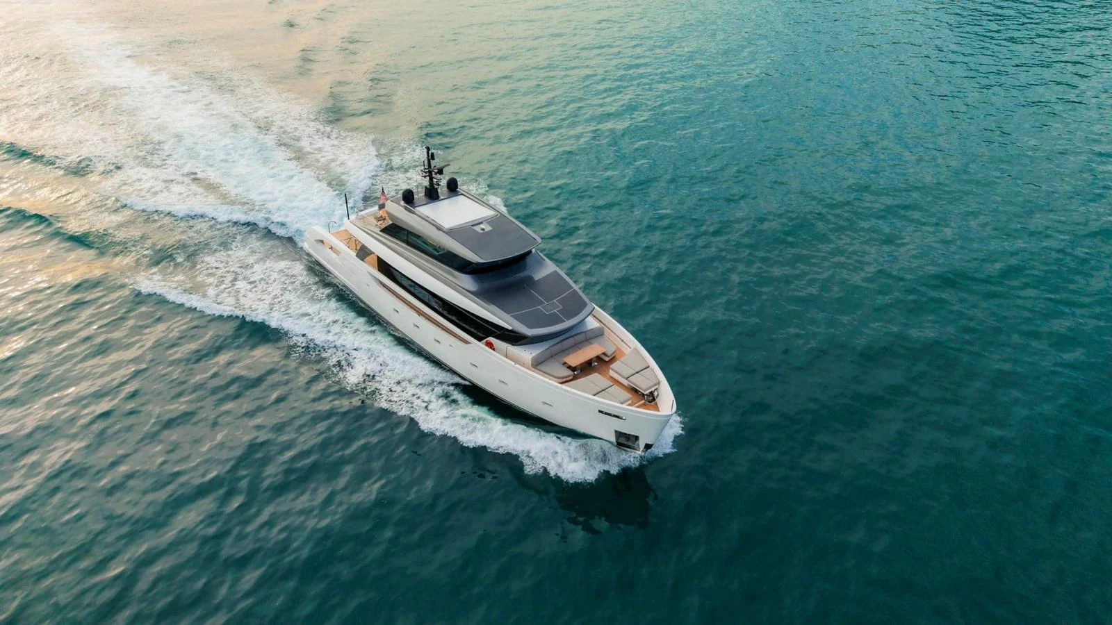 A sleek and modern yacht cruising on calm waters, showcasing its elegant design and spacious deck. aboard SANLORENZO SX100 Yacht for Sale