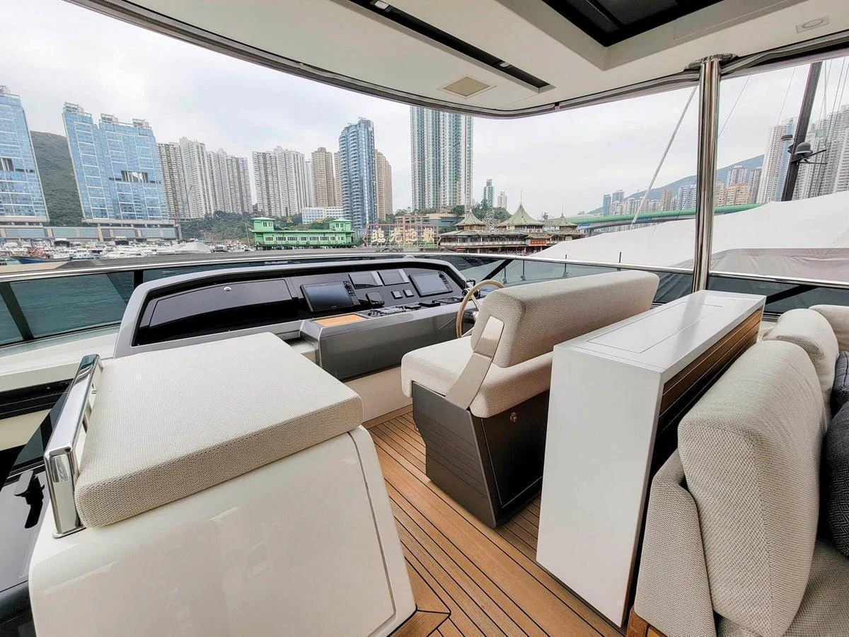 The helm area offers a modern and spacious environment with a stunning cityscape view. aboard SANLORENZO SL86 Yacht for Sale